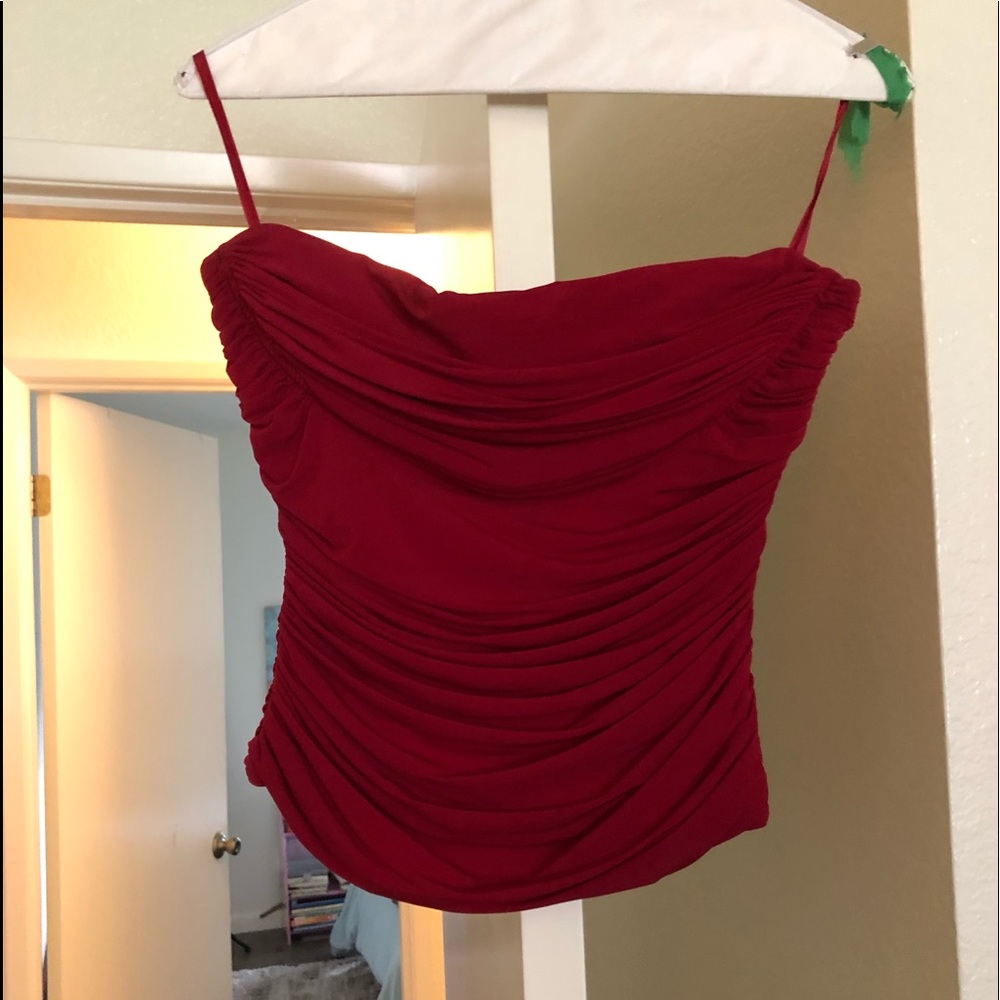 Stunning Strapless Bebe dark red top. Easy to wear zips up the back.